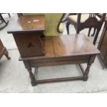 A REPRODUCTION OAK TELEPHONE SEAT WITH CLOVER DECORATION, ON TURNED LEGS