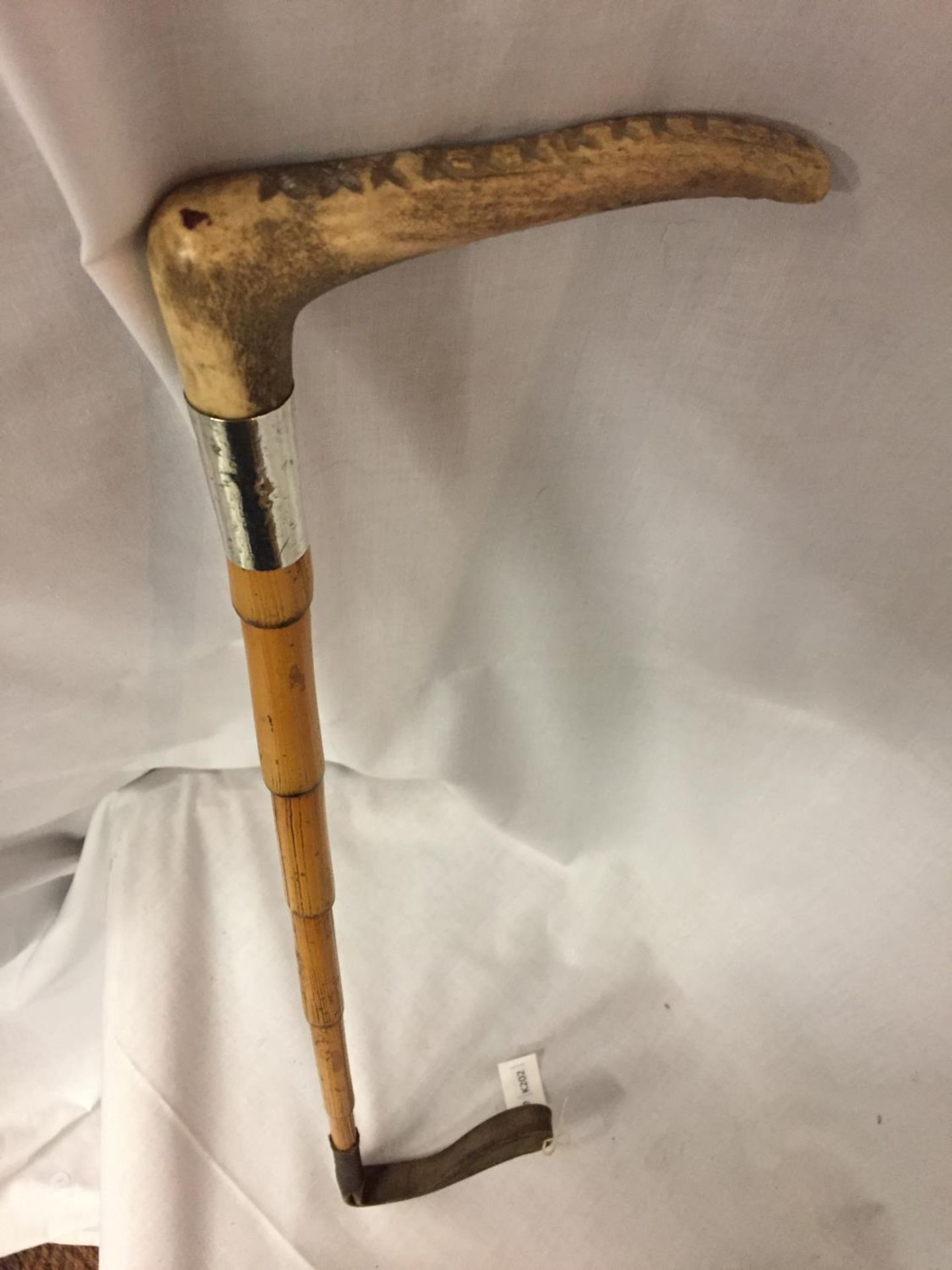 A BAMBOO RIDING CROP WITH HORN HANDLE AND A SILVER COLLAR (INDISTINCT HALLMARK) - Image 2 of 3