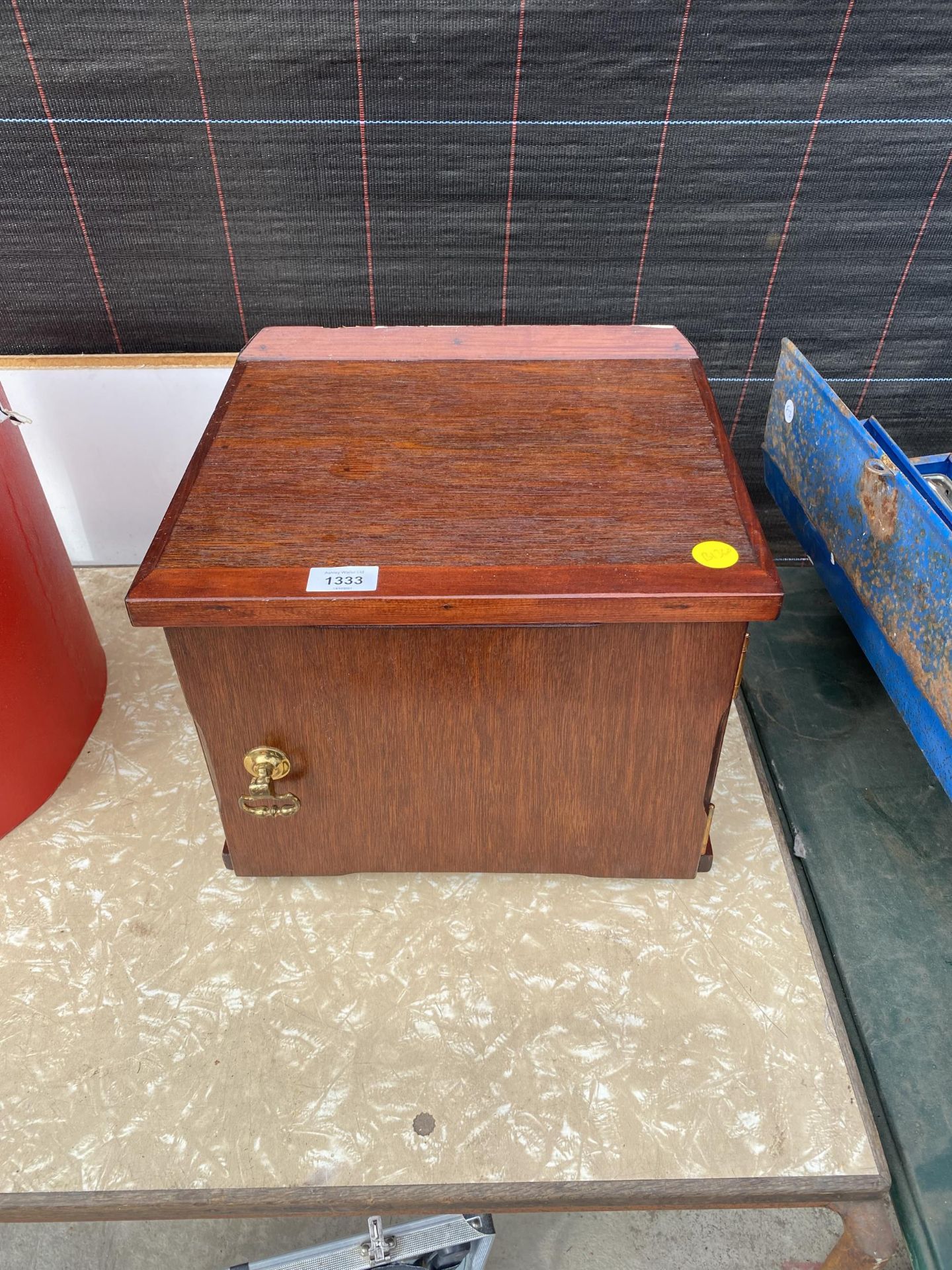 A SMALL WOODEN WALL MOUNTED STORAGE CUPBOARD