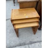 A NEST OF THREE RETRO TEAK TABLES