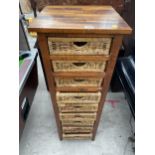 A HARDWOOD CHEST OF NINE WICKER DRAWERS