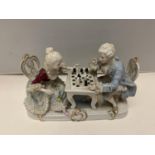 A DRESDEN FIGURINE OF A LADY AND GENTLEMAN PLAYING CHESS