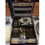 A TWELVE SETTING GOLD PLATED CANTEEN OF CUTLERY WITH SERVING SPOONS,LADELS, CAKE FORKS ETC IN A CASE