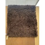 A MODERN BROWN RUG