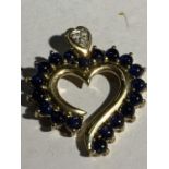 A 9 CARAT GOLD HEART SHAPED PENDANT WITH BLUE STONES GROSS WEIGHT 5 GRAMS