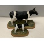 A NORTH LIGHT HAND CRAFTER SCULPTURE OF A FRESIAN COW ON A WOODEN PLINTH AND A MATCHING CALF