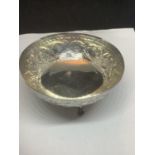 AN ORNATE SILVER BOWL ON THREE BALL AND CLAW STYLE FEET