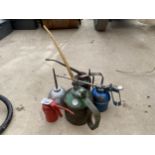 FOUR VINTAGE PUMP ACTION OIL CANS AND A FUNNEL