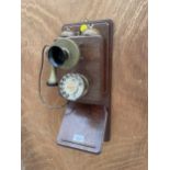 A VINTAGE WALL MOUNTED WOODEN AND BRASS TELEPHONE