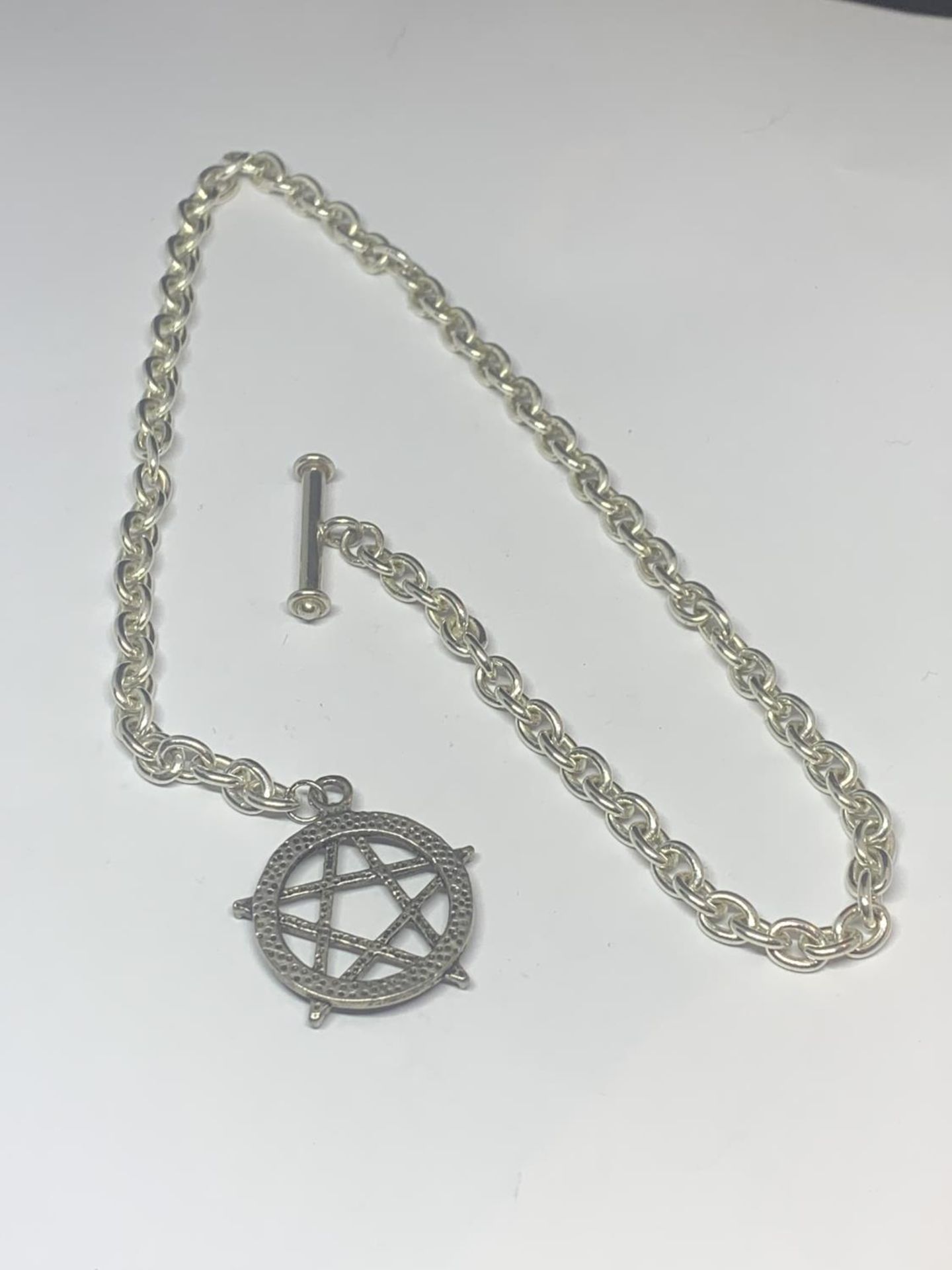 A SILVER WATCH CHAIN WITH A STAR OF DAVID FOB