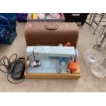A RETRO SEWING MACHINE WITH CARRY CASE