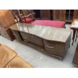 A 1970'S WALNUT EFFECT SIDEBOARD ENCLOSING COCKTAIL CABINET, TWO FURTHER CUPBOARDS AND THREE DRAWERS