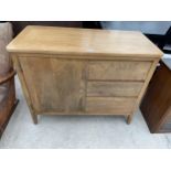 A MODERN OAK SIDE CABINET ENCLOSING THREE DRAWERS AND CUPBOARD, 38" WIDE