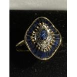 A 9 CARAT GOLD RING IN AN ART DECO STYLE WITH BLUE AND CLEAR STONES SIZE O/P GROSS WEIGHT 2.8 GRAMS