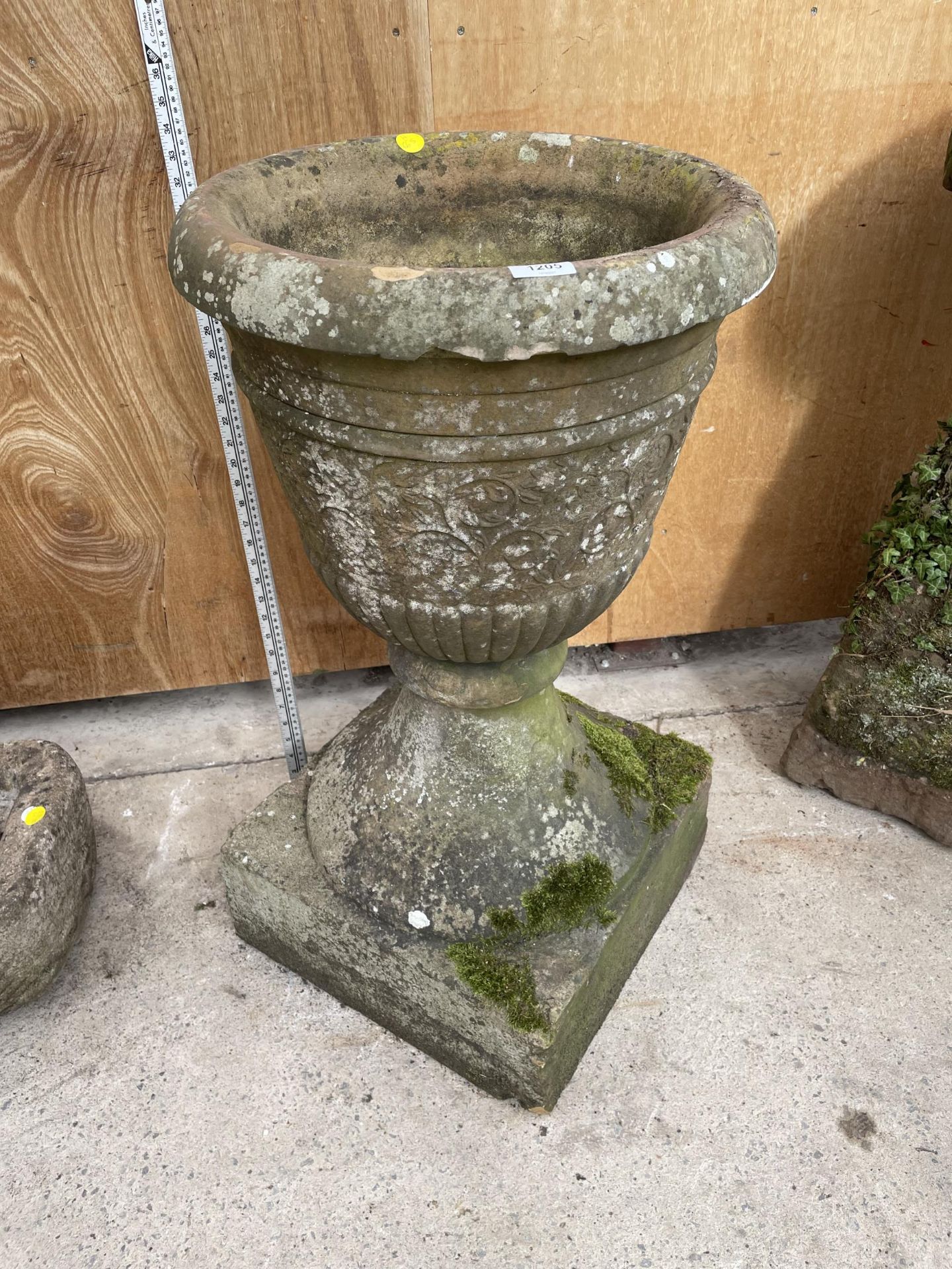 A LARGE STONE URN - APPROXIMATELY 63 CM HIGH