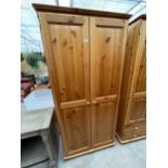 A MODERN PINE TWO DOOR WARDROBE, 34" WIDE