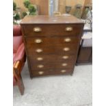 AN EARLY 20TH CENTURY STAINED PINE CHEST OF SIX DRAWERS WITH BRASS SCOOP HANDLES