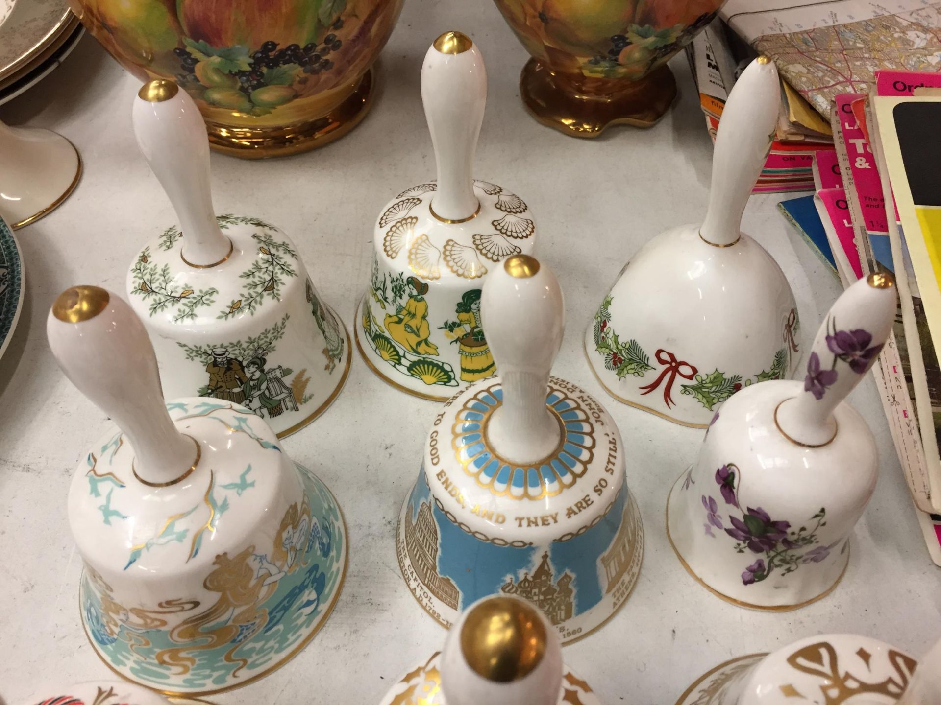 A COLLECTION OF ELEVEN DECORATIVE CERAMIC HAND BELLS - Image 2 of 4