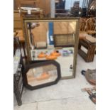 A LARGE DECORATIVE GILT FRAMED BEVELED EDGE MIRROR AND A FURTHER CARVED OAK FRAMED MIRROR