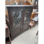 A GLAZED AND LEADED TWO DOOR OLD ABBEY STYLE CABINET, 44" WIDE