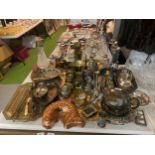A VERY LARGE QUANTITY OF BRASSWARE AND SILVER PLATED ITEMS TO INCLUDE CANDLESTICKS, WALL PLATES,