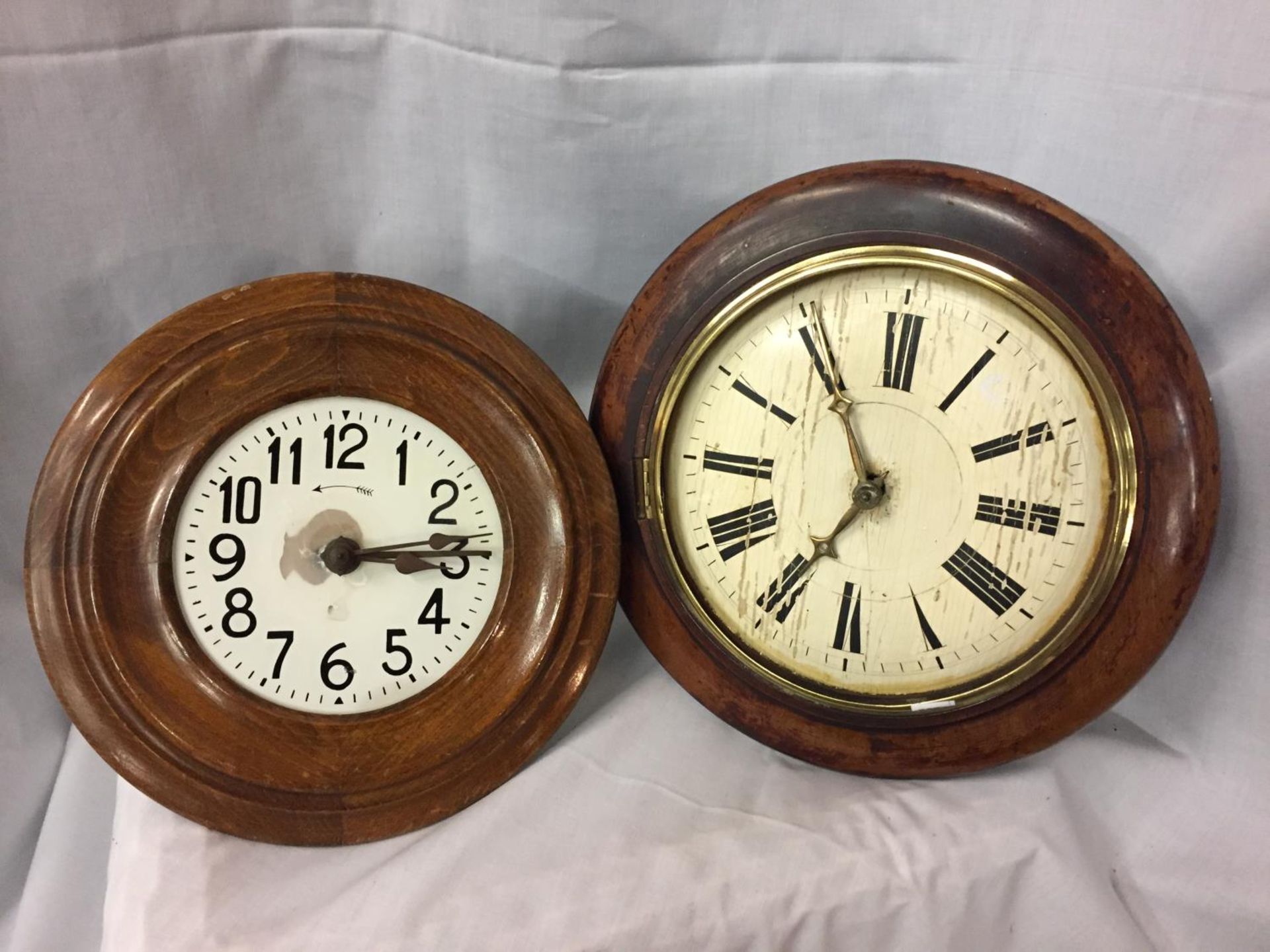 TWO CIRCULAR WOODEN FRAMED WALL CLOCKS