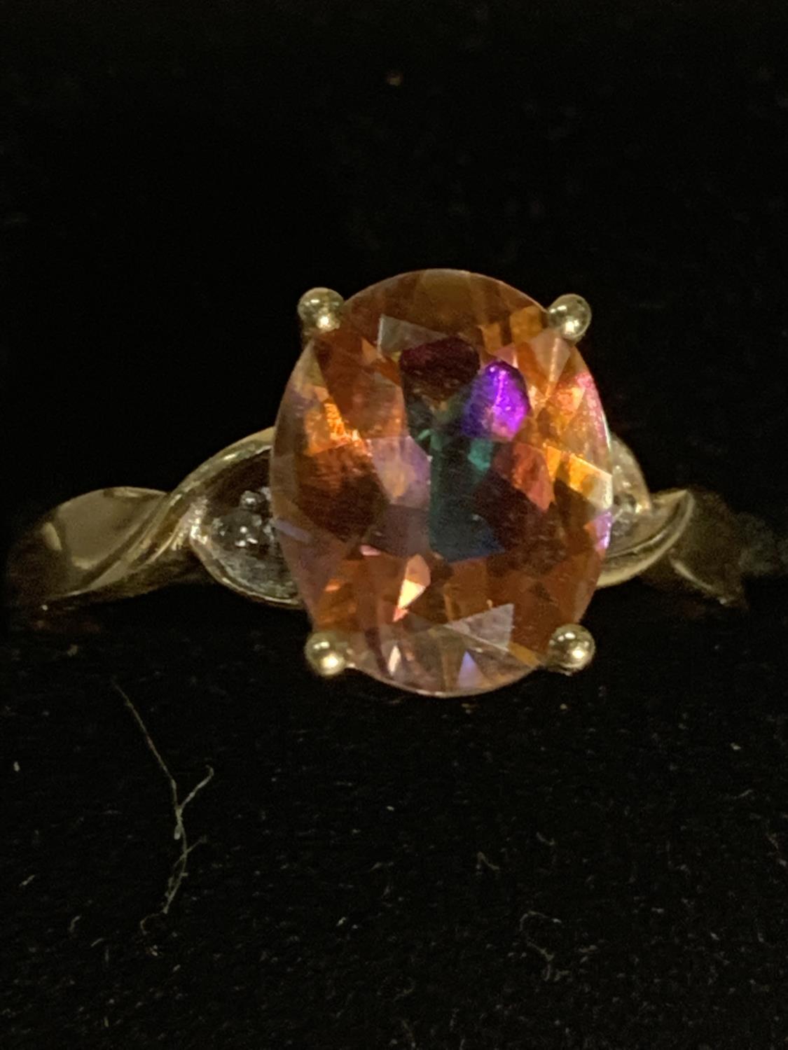 A 9 CARAT GOLD RING WITH A LARGE MULTI COLOURED STONE SIZE P GROSS WEIGHT 2.3 GRAMS