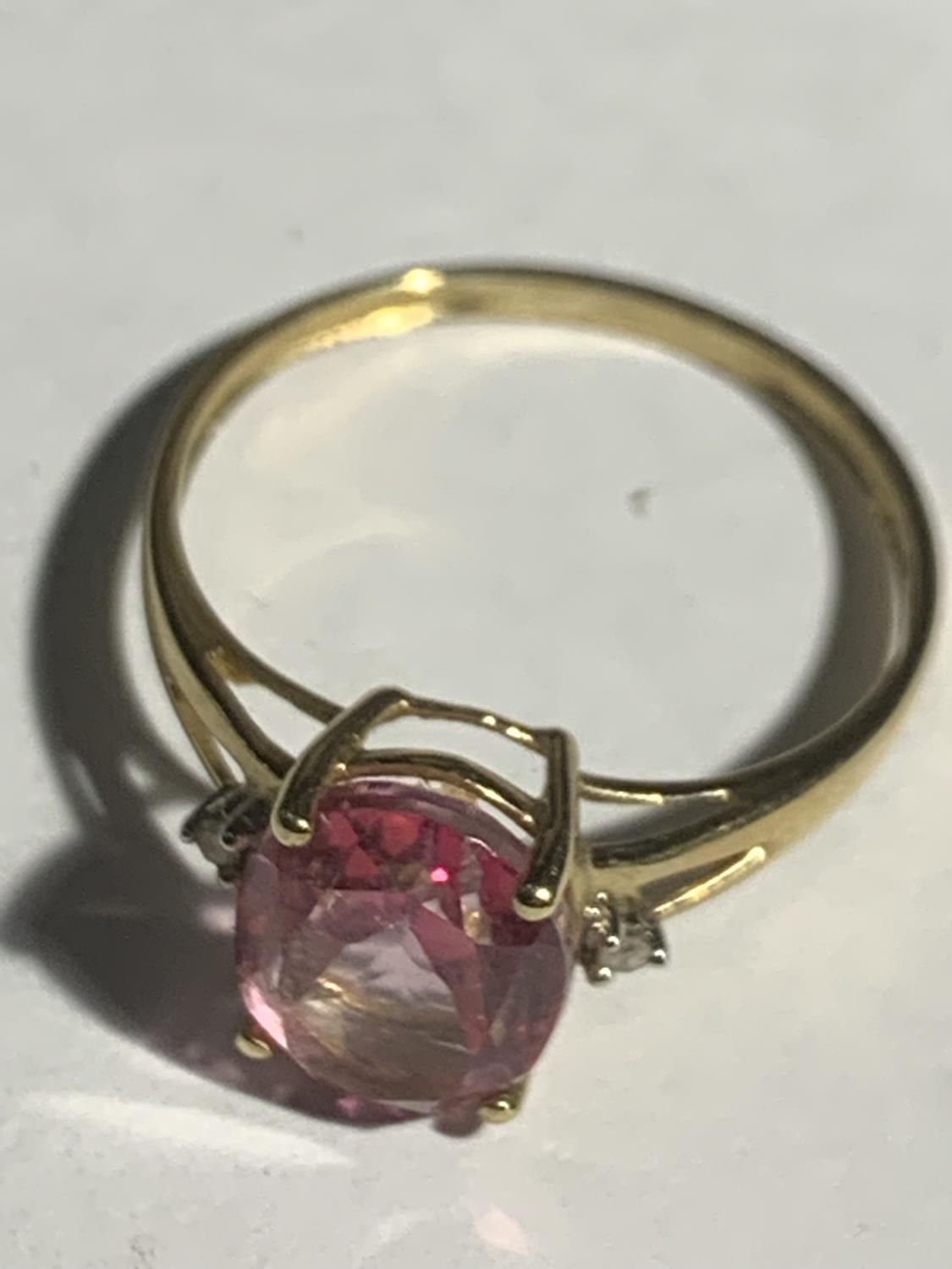 A 9 CARAT GOLD RING WITH A LARGE PINK CENTRE STONE SIZE Q GROSS WEIGHT 1.7 GRAMS - Image 2 of 3