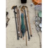 AN ASSORTMENT OF WOODEN WALKING STICKS AND UMBRELLAS ETC