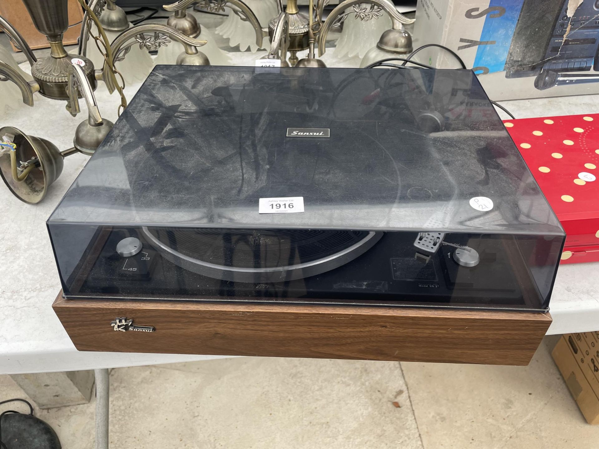 A SANSUI RECORD PLAYER WITH STYLUS
