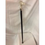 A WALKING CANE WITH A SILVER COLOURED TOP