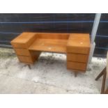 A RETRO TEAK KNEEHOLE DRESSING TABLE