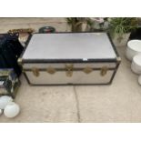 AN ALLUMINIUM COVERED TRAVEL TRUNK WWITH BRASS CLASPS