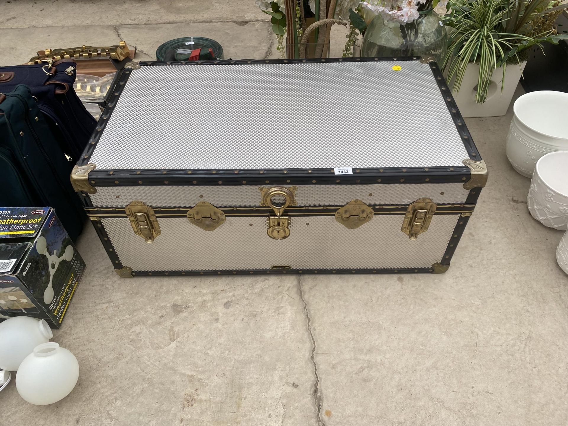 AN ALLUMINIUM COVERED TRAVEL TRUNK WWITH BRASS CLASPS