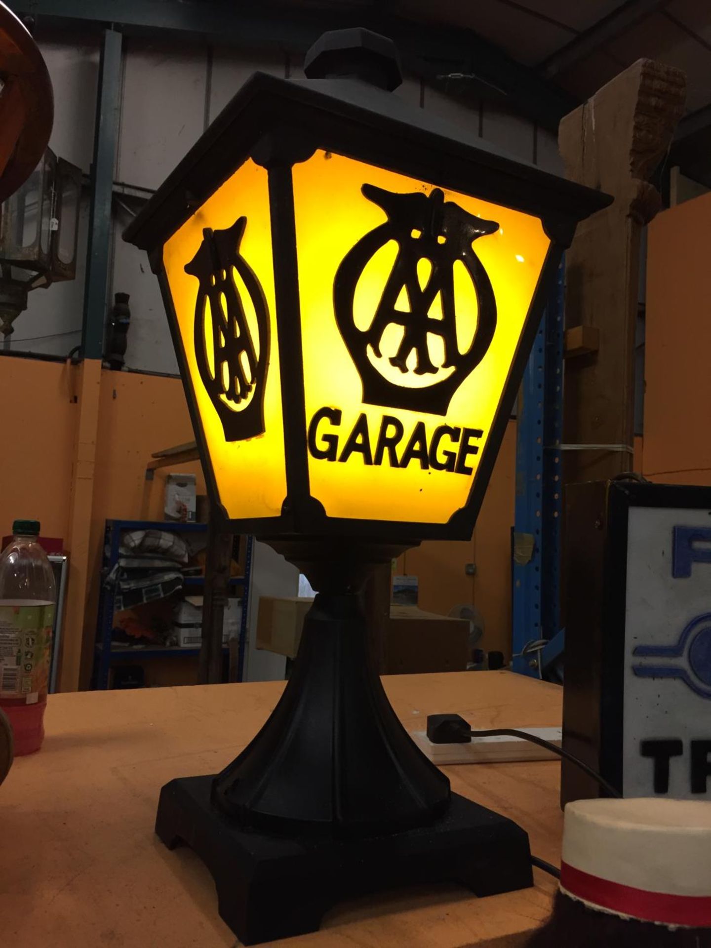 A CAST METAL LAMP WITH AA GARAGE THREE SIDED DETAIL TO PANELS AND BELIEVED IN WORKING ORDER BUT NO - Image 4 of 4