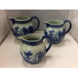 A SET OF THREE ' VICTORIA WARE ' BLUE AND WHITE GRADUATED JUGS