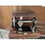 A VINTAGE SINGER SEWING MACHINE WITH WOODEN CARRY CASE AND KEY