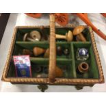 A WICKER BASKET COMPLETE WITH A NUMBER OF SOCK DARNING MUSHROOMS AND WOODEN CONES