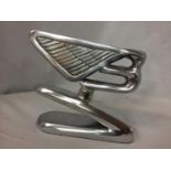 A CHROME BENTLEY B LOGO ON A STAND