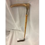 A BAMBOO RIDING CROP WITH HORN HANDLE AND A SILVER COLLAR (INDISTINCT HALLMARK)