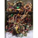 A METAL CASH BOX CONTAINING COSTUME JEWELLERY TO INCLUDE MAINLY BEADED NECKLACES