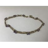 A 9 CARAT GOLD BRACELET WITH AMETHYSTS MARKED 9K GROSS WEIGHT 4.6 GRAMS