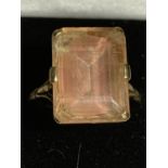 A 9 CARAT GOLD RING WITH A LARGE CORAL TINGED CENTRE STONE SIZE N/O GROSS WEIGHT 4.8 GRAMS