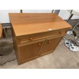 A RETRO TEAK TWO DOOR CABINET WITH SINGLE DRAWER, 33" WIDE, LABELLED SUTCLIFFE FURNITURE, TODMORDEN