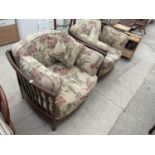 A PAIR OF ERCOL RENAISSANCE EASY CHAIRS WITH FLORAL UPHOLSTERY AND CUSHIONS