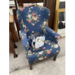 A PARKER KNOLL STYLE WINGED FIRESIDE CHAIR