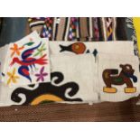 AN ASSORTMENT OF ANIMAL THEMED TEXTILES IN THE AZTEC STYLE