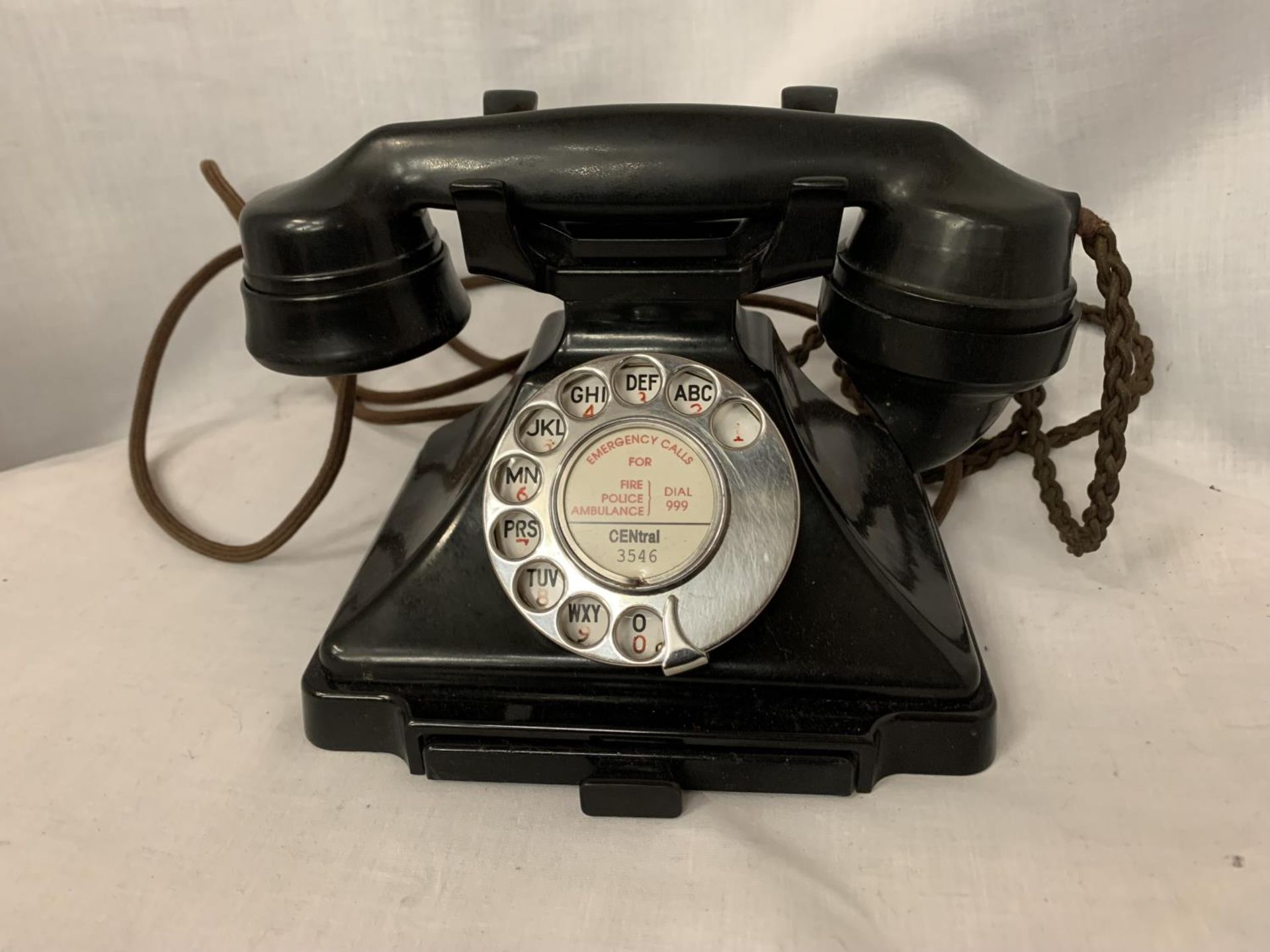 A VINTAGE BLACK BAKELITE TELEPHONE WITH NUMBER STORAGE DRAWER