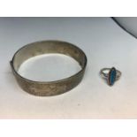 A HALLMARKED BIRMINGHAM SILVER BANGLE AND A SILVER RING WITH A TURQUOISE STONE