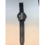 A CHRONOGRAPH WRIST WATCH WITH A BLACK LEATHER STRAP SEEN WORKING BUT NO WARRANTY